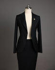 A Charcoal black notch lapel suit with skirt.